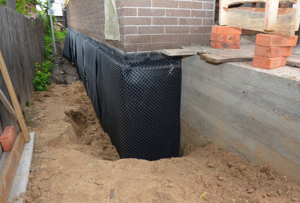 Happy homeowners after waterproofing job in Phelps